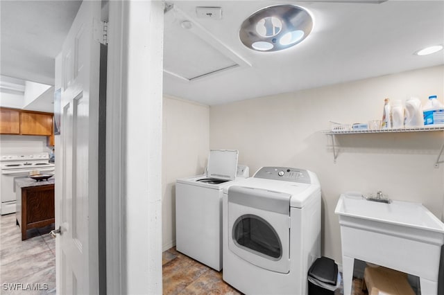 washroom featuring independent washer and dryer and sink