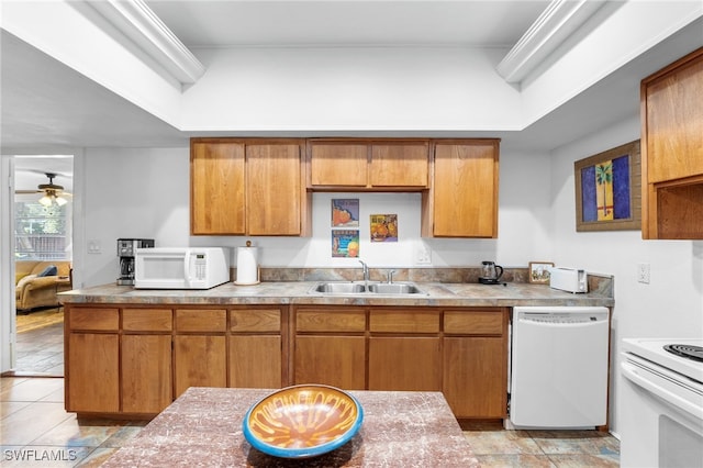 kitchen with white appliances, ceiling fan, and sink