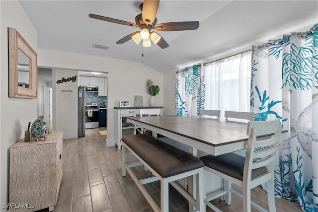 dining room featuring ceiling fan and vaulted ceiling