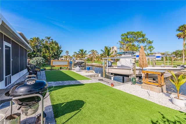 view of yard with a dock and a water view