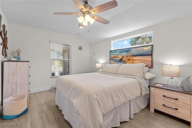 bedroom featuring ceiling fan, lofted ceiling, and light hardwood / wood-style flooring