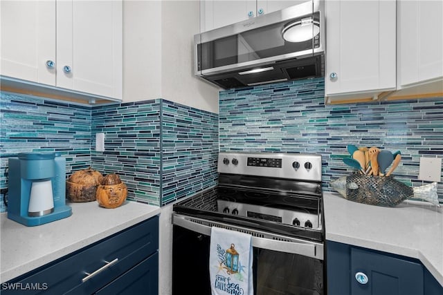 kitchen with white cabinetry, stainless steel appliances, and blue cabinets