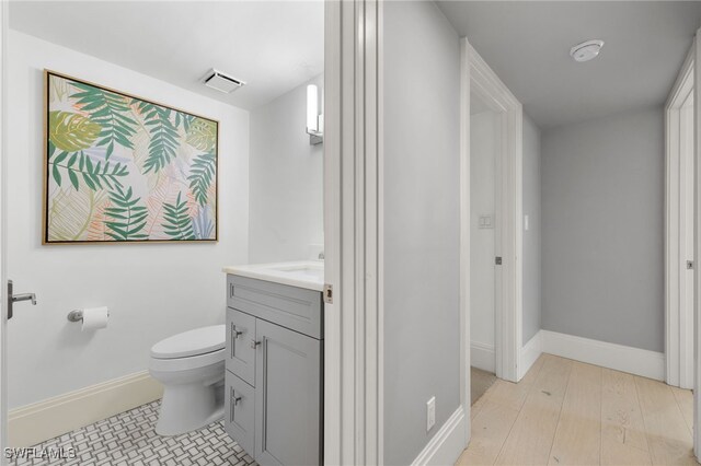 bathroom featuring hardwood / wood-style floors, vanity, and toilet