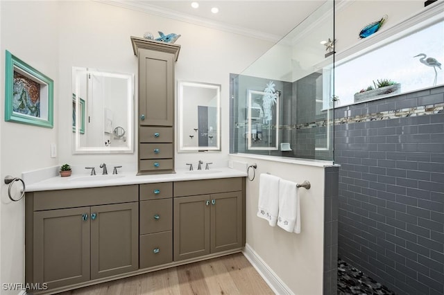 full bathroom featuring a walk in shower, double vanity, a sink, and crown molding