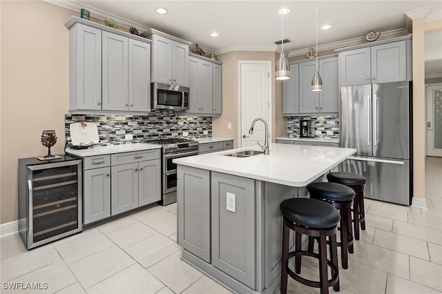 17773 Vaca Ct, Fort Myers, FL 33908 - kitchen with stainless steel appliances, gray cabinets, wine cooler, a sink, and tasteful backsplash