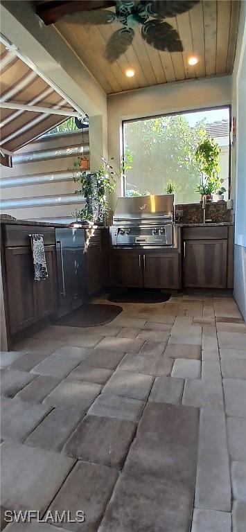 view of patio / terrace with ceiling fan, an outdoor kitchen, grilling area, and a sink