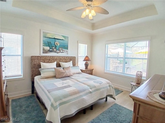 17773 Vaca Ct, Fort Myers, FL 33908 - bedroom with a raised ceiling, crown molding, baseboards, wood finished floors, and a ceiling fan