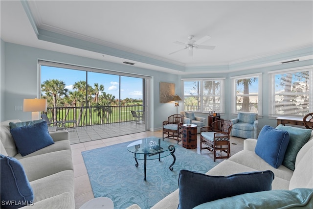 living room featuring light tile patterned floors, crown molding, ceiling fan, and a healthy amount of sunlight