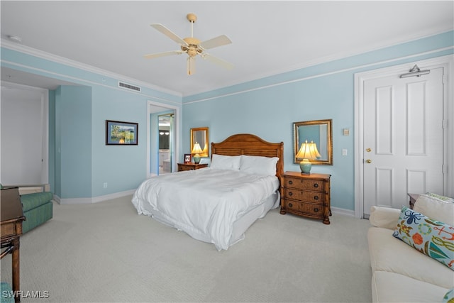 carpeted bedroom with ceiling fan and crown molding