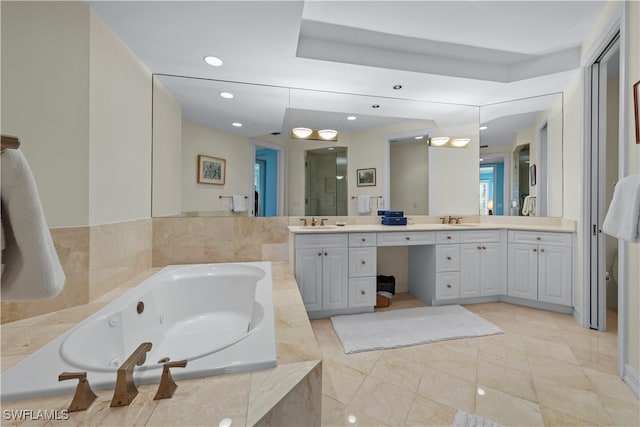 bathroom featuring shower with separate bathtub and vanity