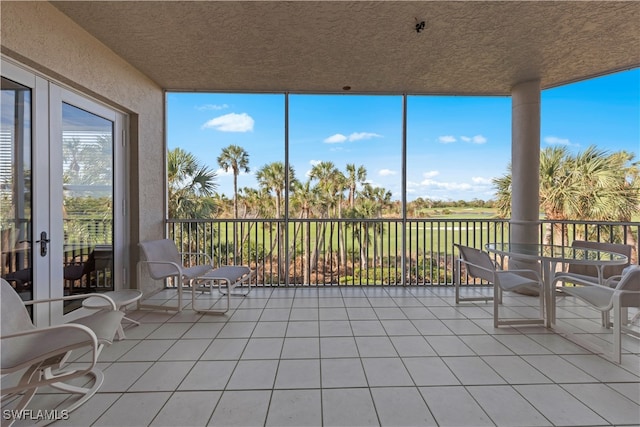 unfurnished sunroom featuring french doors