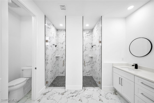 bathroom with vanity, toilet, and a shower with door