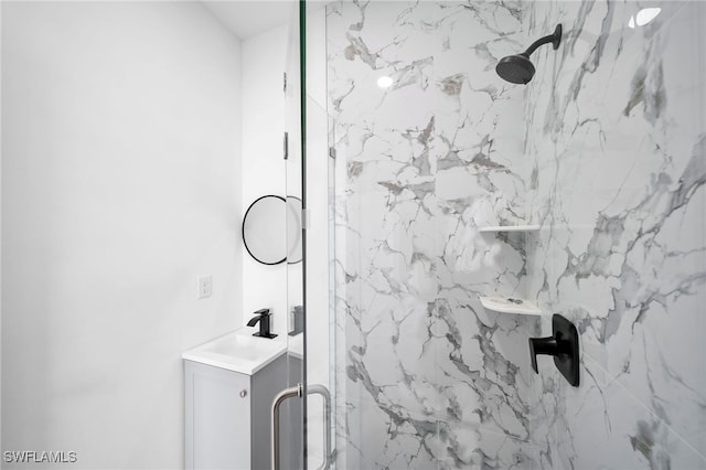 bathroom featuring tiled shower and sink