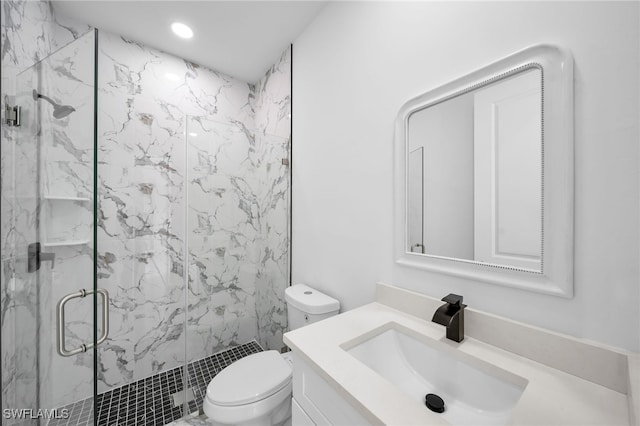 bathroom featuring vanity, toilet, and an enclosed shower