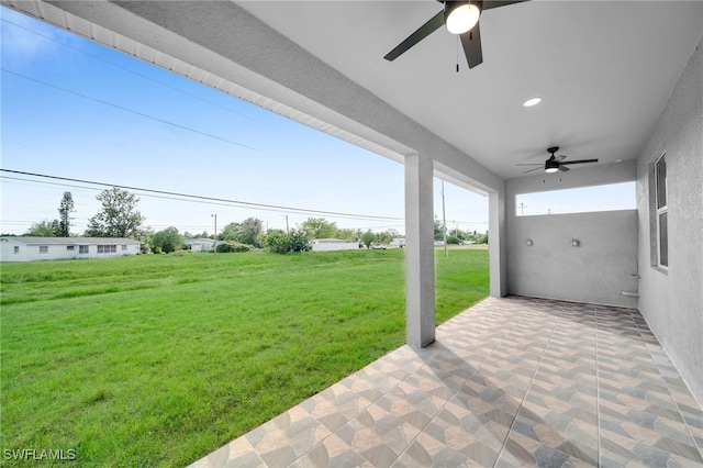 view of yard with ceiling fan and a patio