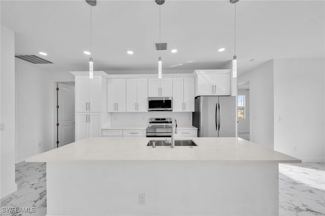 kitchen with a large island, hanging light fixtures, white cabinets, and stainless steel appliances