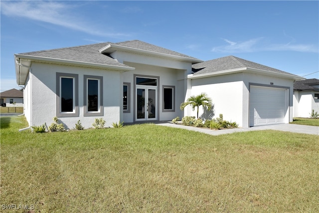 exterior space with a lawn, french doors, and a garage