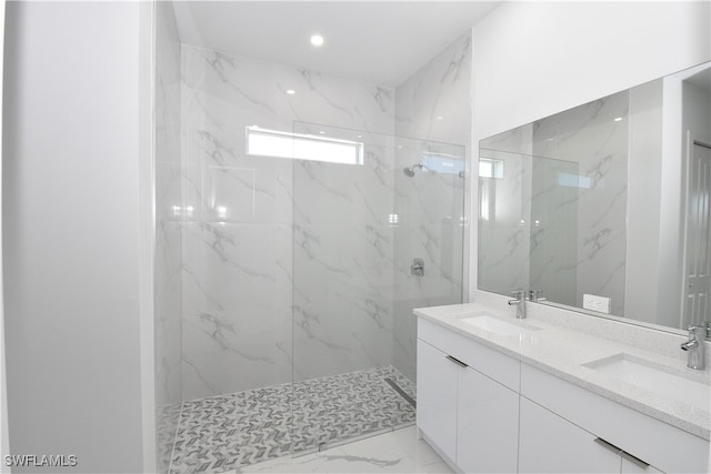 bathroom featuring vanity and tiled shower