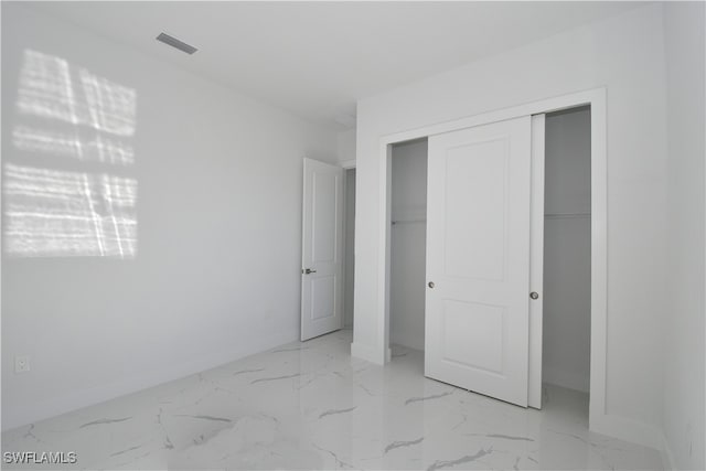 unfurnished bedroom with a closet