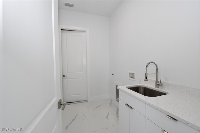 clothes washing area with hookup for an electric dryer, cabinets, sink, and hookup for a washing machine