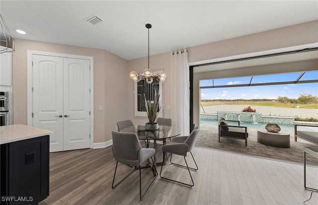 dining room featuring hardwood / wood-style flooring and a notable chandelier