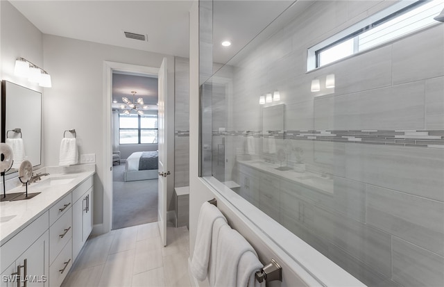 bathroom with tiled shower, vanity, tile patterned floors, and plenty of natural light