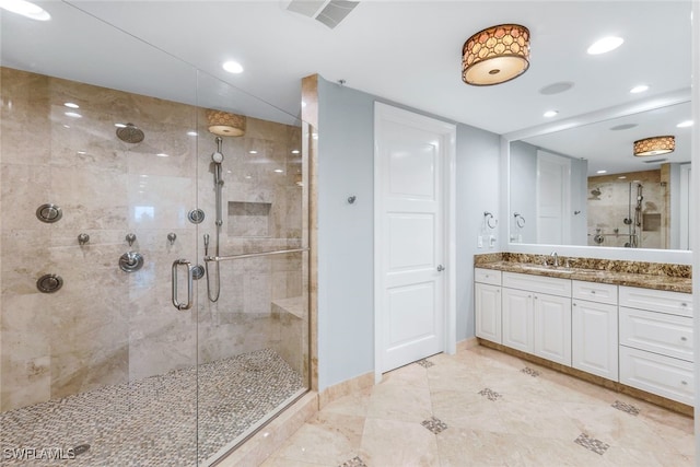 bathroom with vanity and an enclosed shower