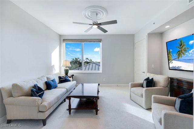 carpeted living room with ceiling fan