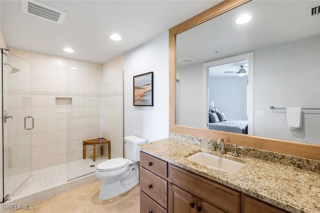 bathroom featuring walk in shower, vanity, ceiling fan, tile patterned flooring, and toilet