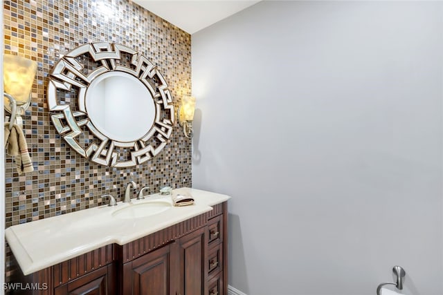 bathroom featuring vanity and backsplash