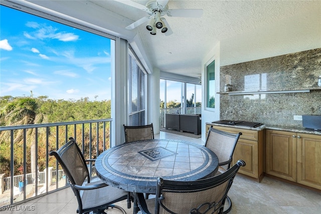 sunroom featuring ceiling fan