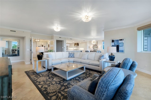 living room with ornamental molding and an inviting chandelier