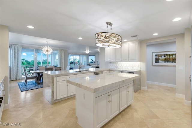 kitchen with pendant lighting, a kitchen island, kitchen peninsula, and a wealth of natural light