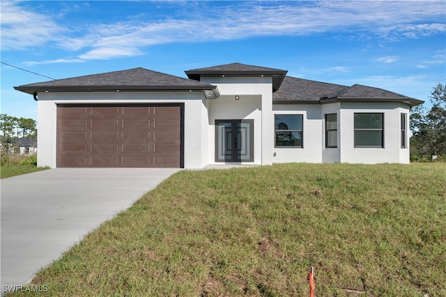 prairie-style house with a front lawn and a garage