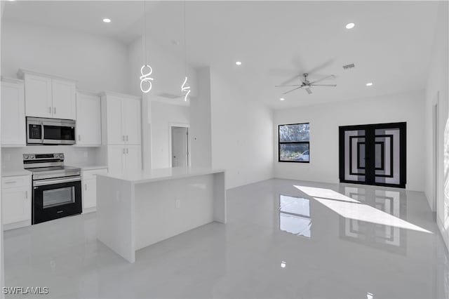 kitchen with ceiling fan, stainless steel appliances, decorative light fixtures, decorative backsplash, and white cabinets