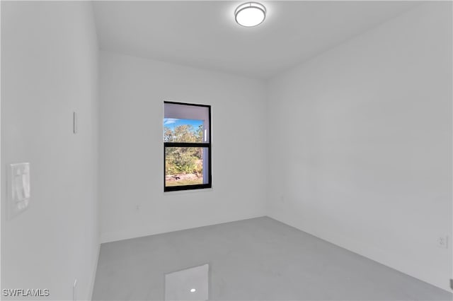 unfurnished room featuring concrete flooring