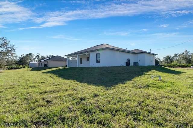 view of side of property with a lawn and central air condition unit