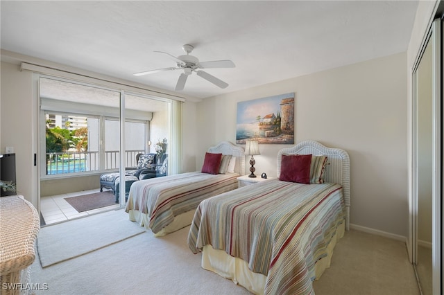 bedroom featuring access to outside, light colored carpet, and ceiling fan