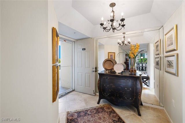 hallway with light tile patterned floors and an inviting chandelier