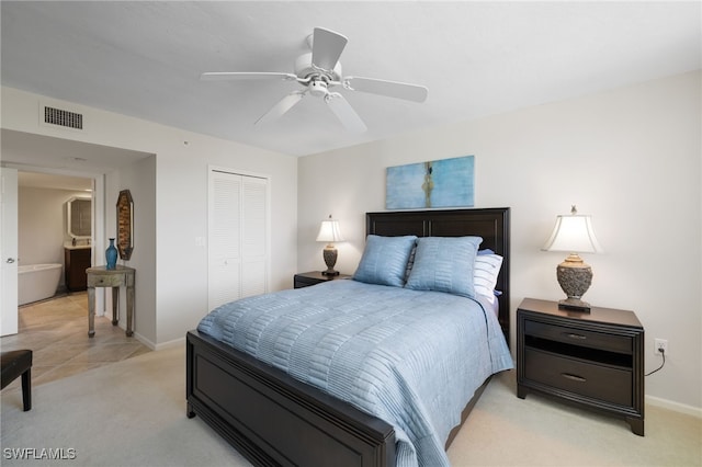 carpeted bedroom featuring ceiling fan and a closet