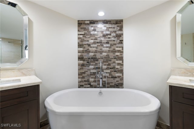 bathroom with vanity and a washtub