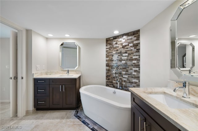 bathroom featuring vanity, tile patterned floors, and a bathing tub