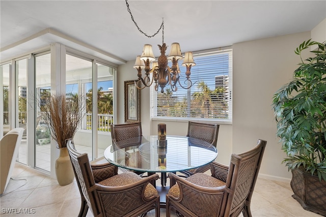 tiled dining area featuring a chandelier