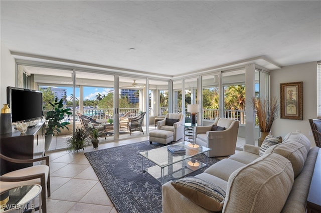 tiled living room featuring floor to ceiling windows