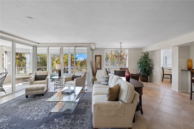 living room with tile patterned floors and a chandelier