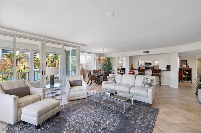 tiled living room with an inviting chandelier