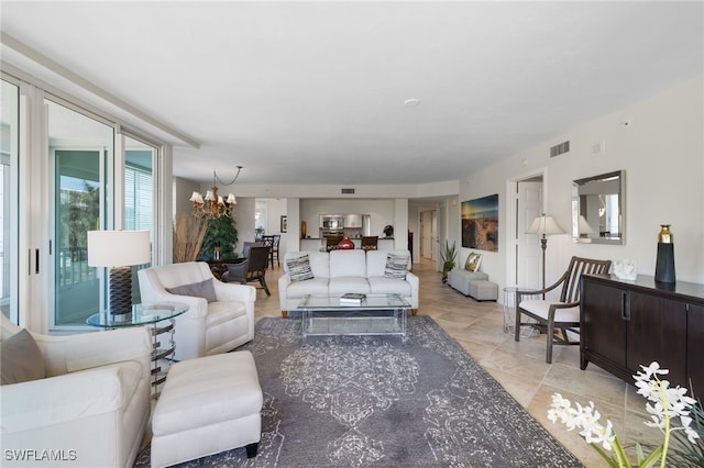 living room featuring light tile patterned floors and a notable chandelier