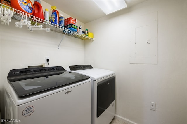 laundry room featuring electric panel and washer and clothes dryer