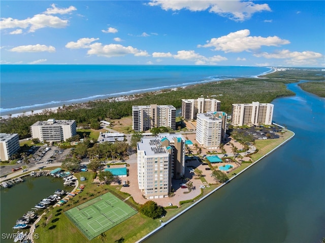 drone / aerial view featuring a water view and a beach view