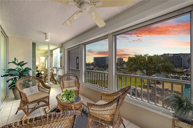 sunroom / solarium featuring ceiling fan